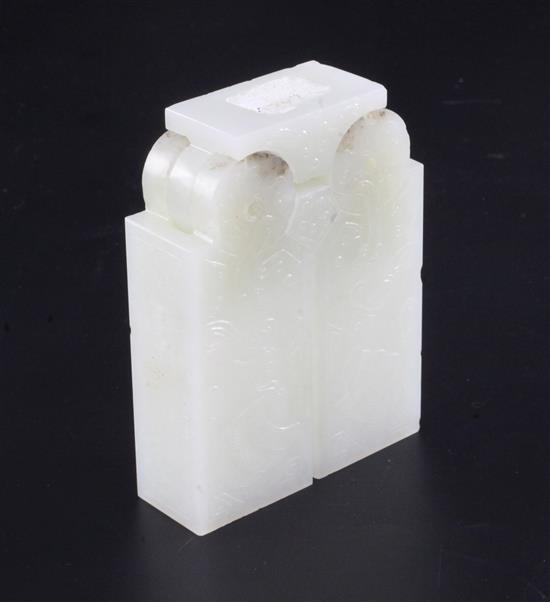 A Chinese archaistic pale celadon jade vessel or instrument, 9.5cm